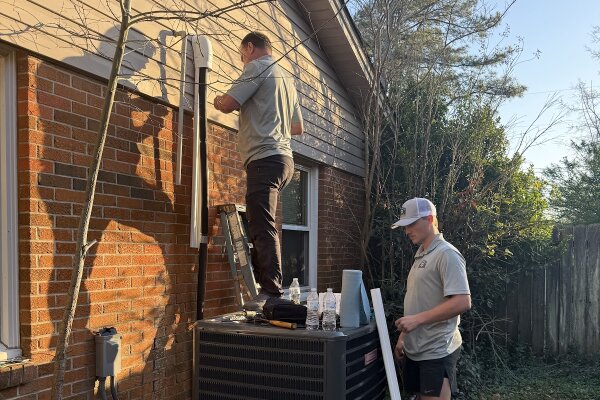 HVAC repair in Mobile, AL by Magnolia Air Solutions technicians Adrian and Connor installing a new residential HVAC system.